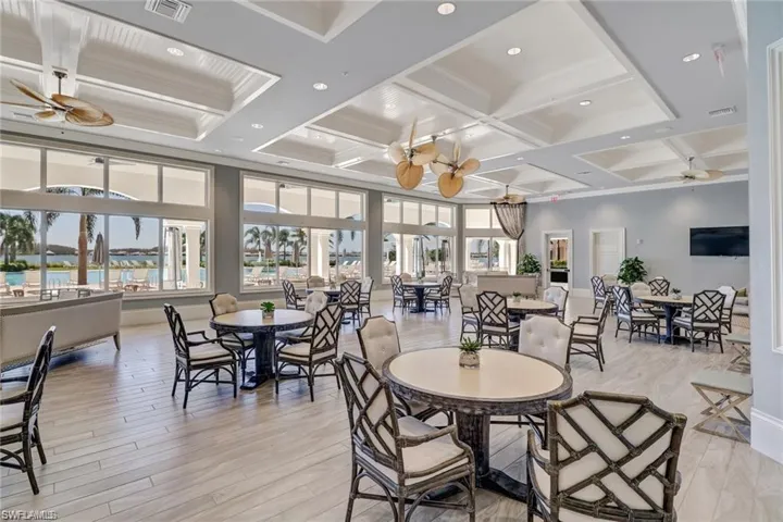 Dining area with beamed ceiling, ceiling fan, coffered ceiling, and light hardwood / wood-style flooring