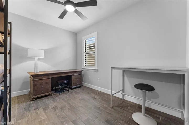 Office area featuring wood-type flooring and ceiling fan