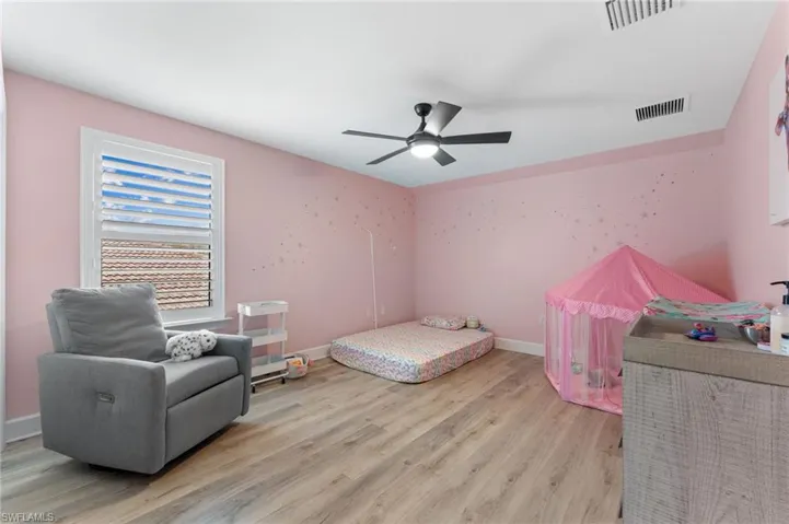 Bedroom featuring ceiling fan and light hardwood / wood-style flooring