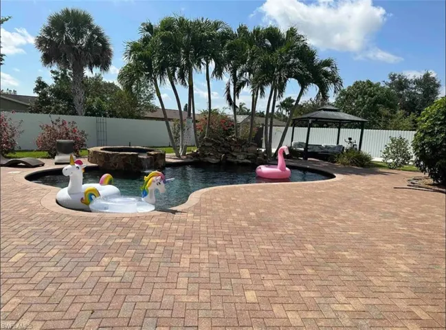 View of patio featuring a fenced in pool and a gazebo