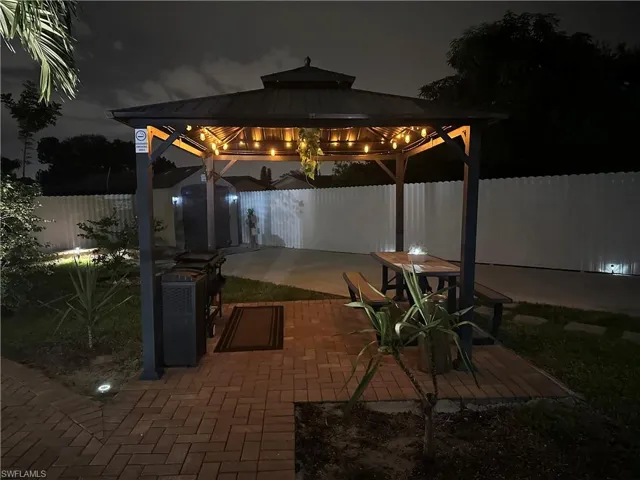 Patio at night with a gazebo