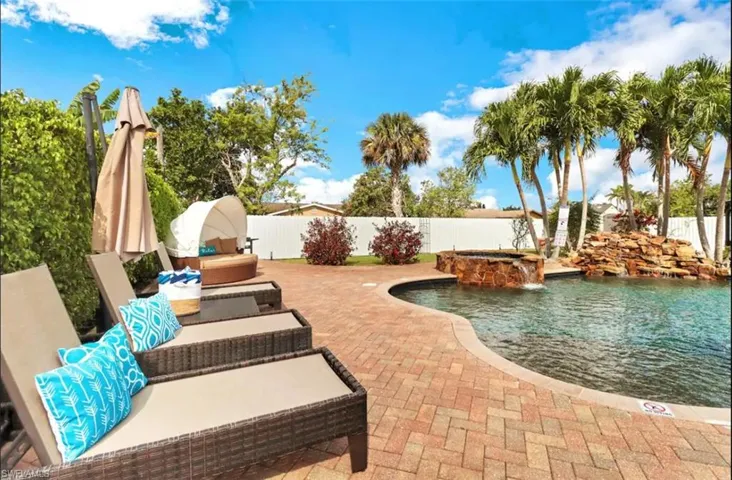 View of patio featuring a fenced in pool and pool water feature