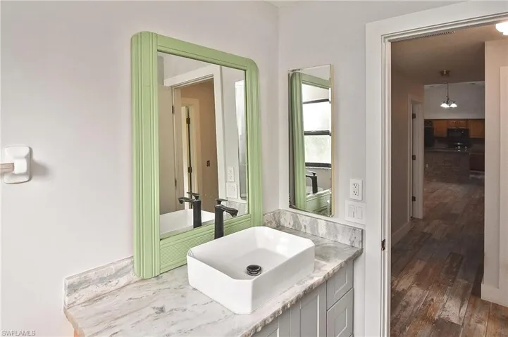 Bathroom featuring hardwood / wood-style flooring and vanity