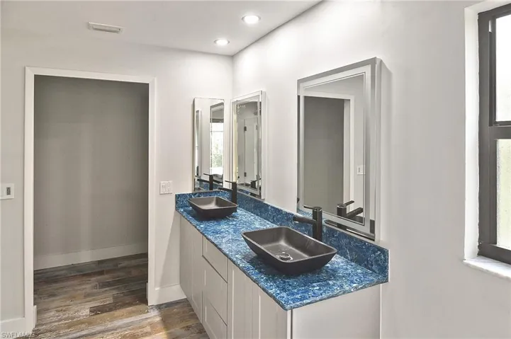Bathroom with vanity and hardwood / wood-style floors