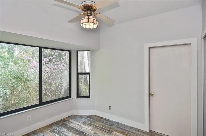 Spare room with hardwood / wood-style flooring and ceiling fan