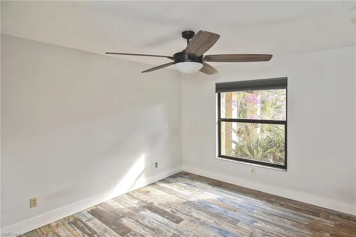 Spare room with hardwood / wood-style floors and ceiling fan
