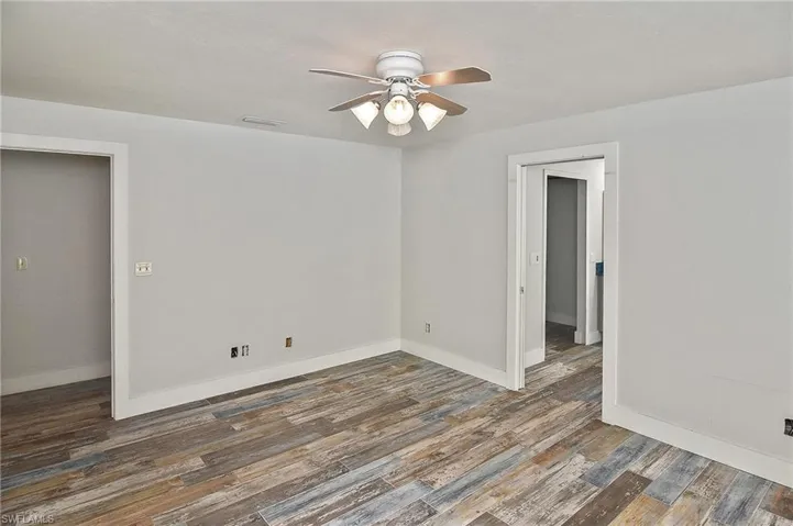 Spare room featuring dark hardwood / wood-style floors and ceiling fan