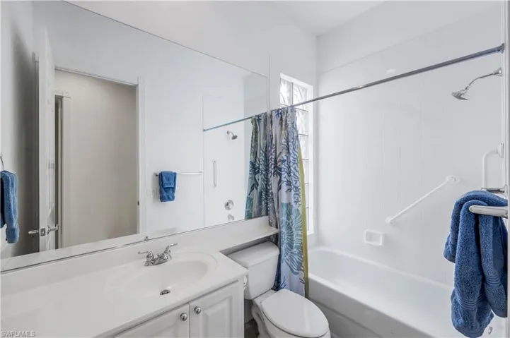Bathroom featuring shower / bath combo and vanity