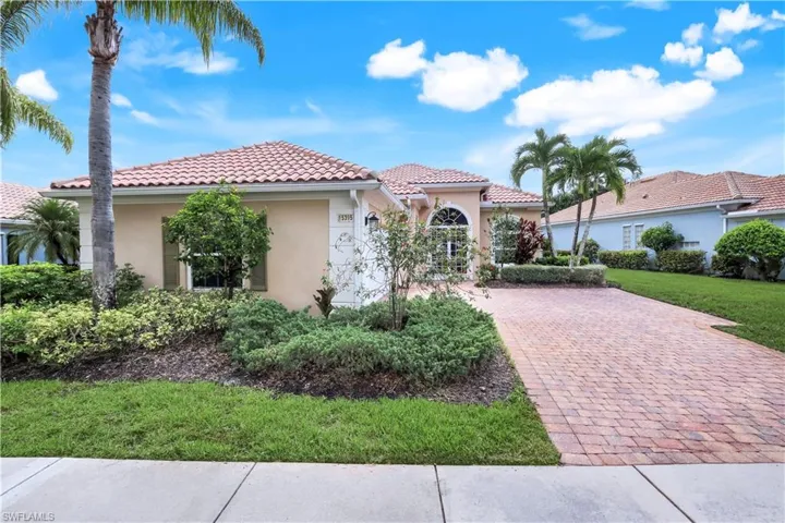 Mediterranean / spanish house featuring stucco siding, a tiled roof, and a front lawn