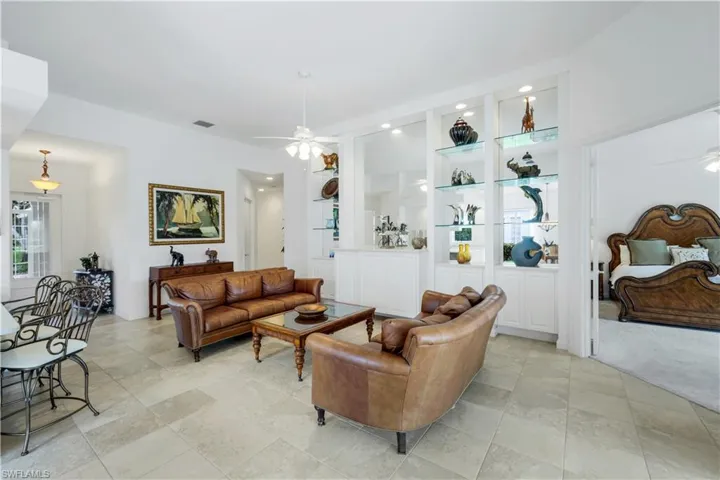 Living area featuring a ceiling fan, recessed lighting, and built in shelves