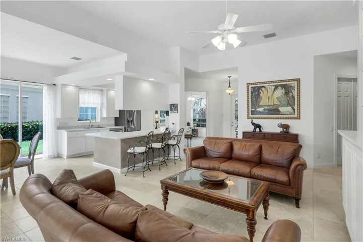 Living room featuring a ceiling fan and light tile patterned floors