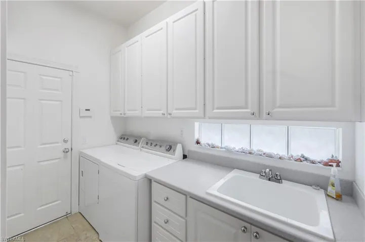 Laundry room featuring cabinet space and washing machine and clothes dryer