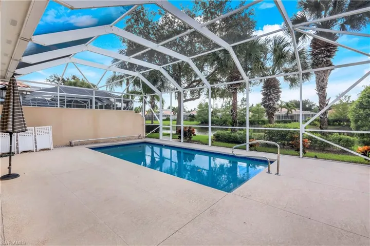 Outdoor pool featuring a lanai, a patio area, and a sunroom