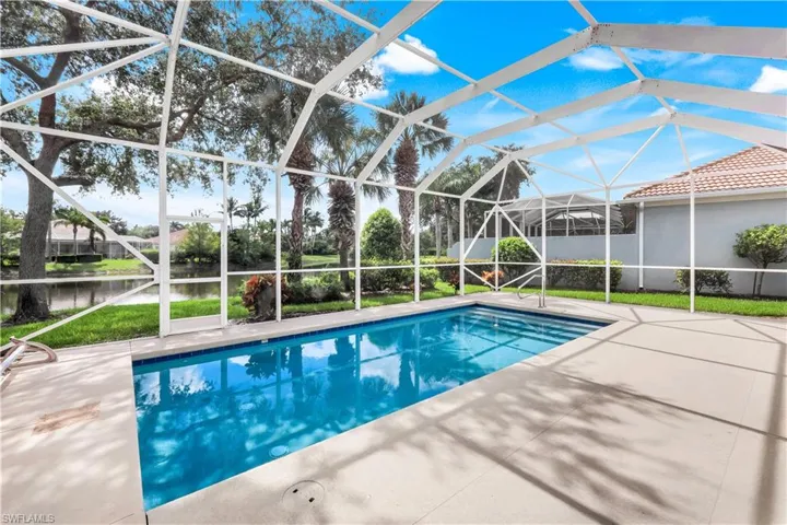 Swimming pool featuring a water view, a lanai, a patio, and a sunroom