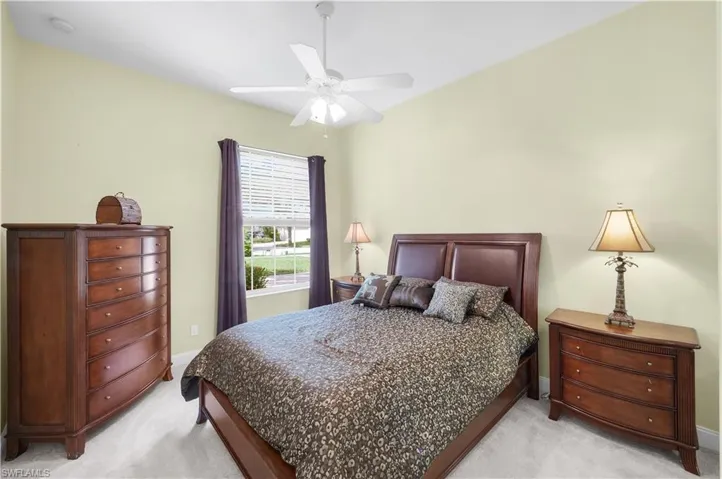 Bedroom featuring light carpet and a ceiling fan