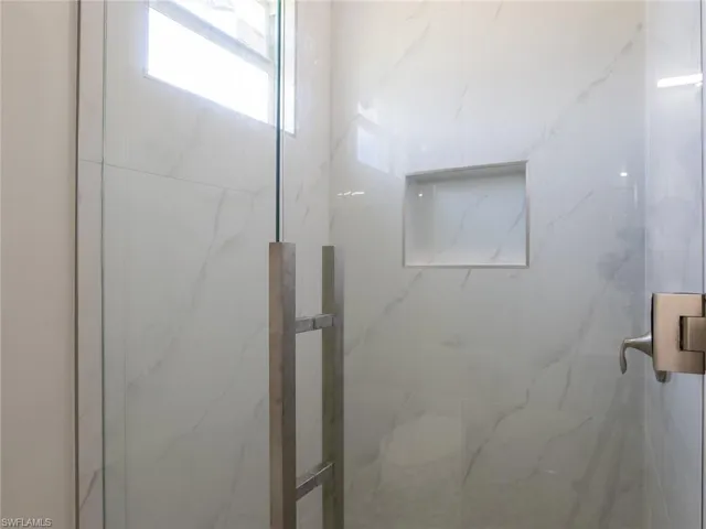 Bathroom featuring a shower with door