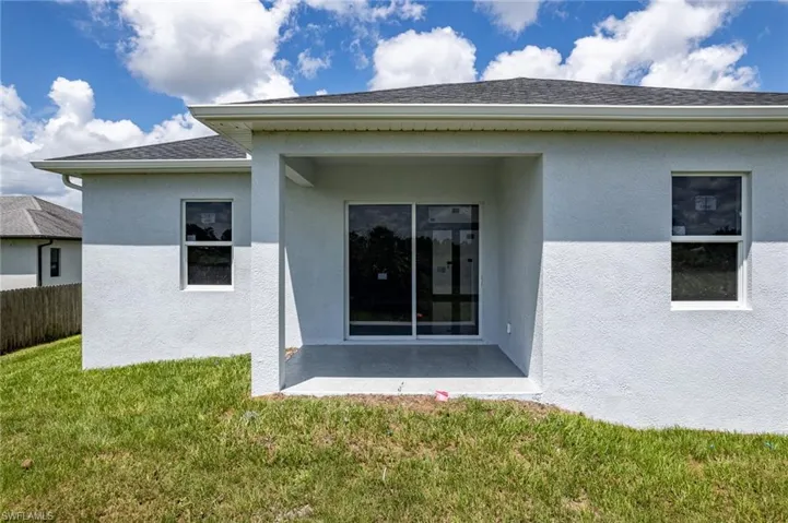 Rear view of property featuring a yard