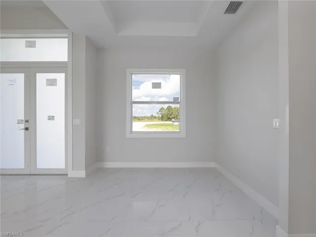 Spare room with a tray ceiling