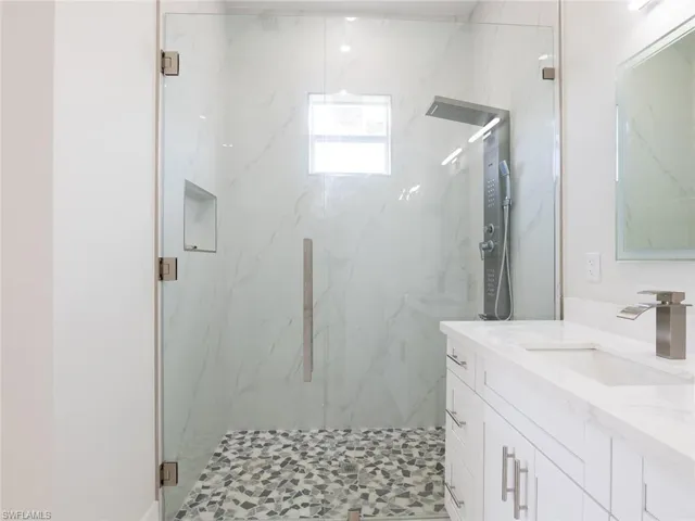 Bathroom with an enclosed shower and vanity