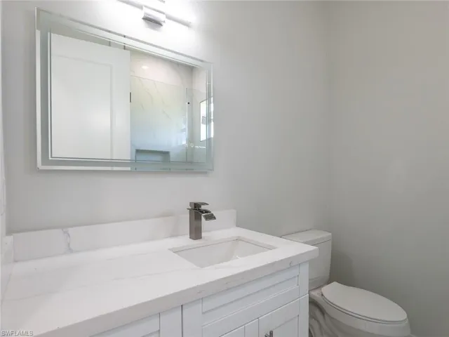 Bathroom featuring vanity and toilet