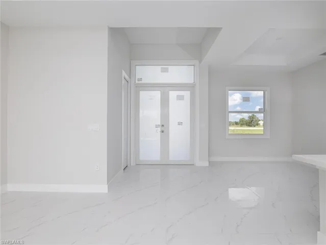 Tiled entryway with french doors