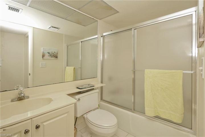 Guest bath with tub/shower/glass doors.