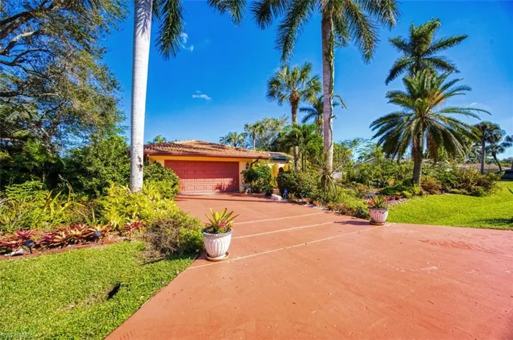 Mediterranean / spanish home with a garage and a front lawn