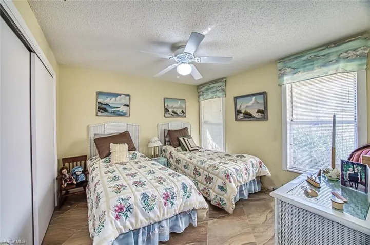 Bedroom featuring a textured ceiling, a closet, and ceiling fan