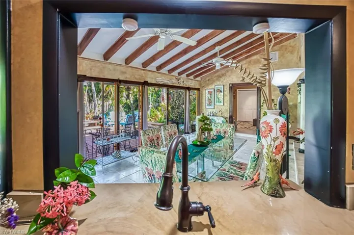 Sunroom / solarium with lofted ceiling with beams