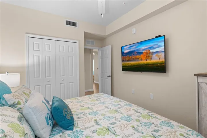 Bedroom featuring visible vents, a closet, and ceiling fan