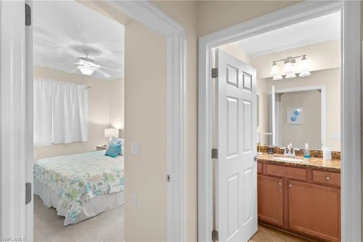 Ensuite bathroom with vanity, tile patterned flooring, ensuite bathroom, and ceiling fan