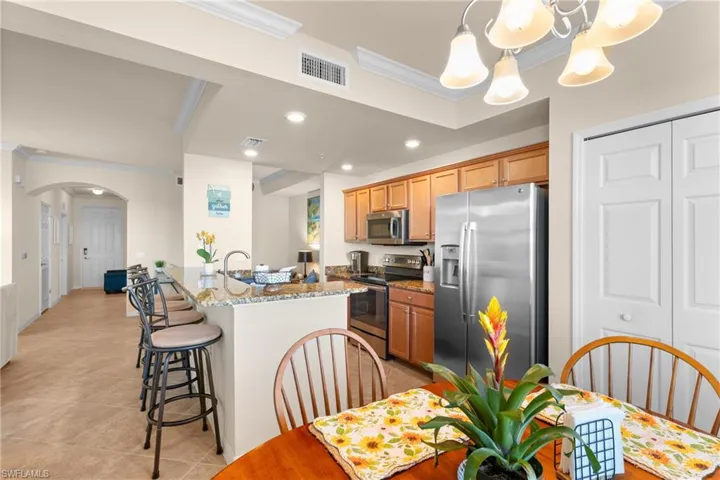 Kitchen featuring crown molding, arched walkways, visible vents, and stainless steel appliances