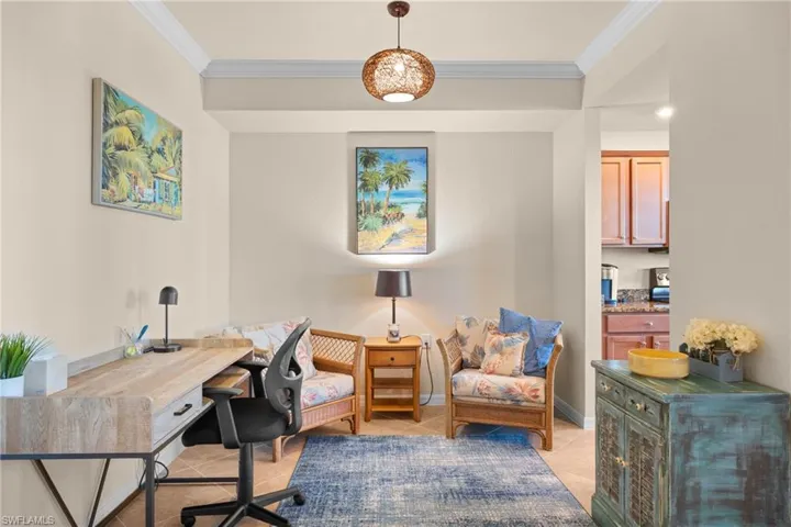 Office area featuring light tile patterned floors, baseboards, and crown molding