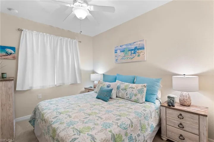Bedroom with baseboards, carpet, and ceiling fan