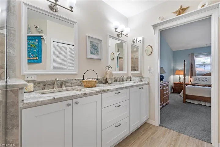 Bathroom featuring dual vanity and wood-type flooring