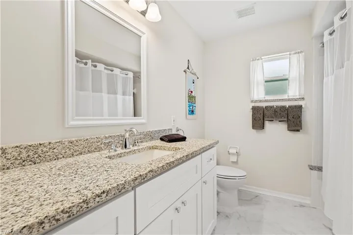 Bathroom with vanity, tile patterned flooring, and toilet