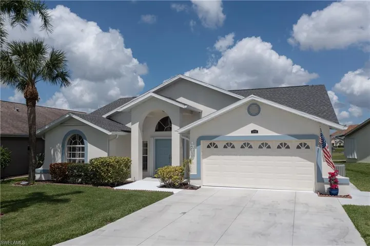 Ranch-style home with a garage and a front yard
