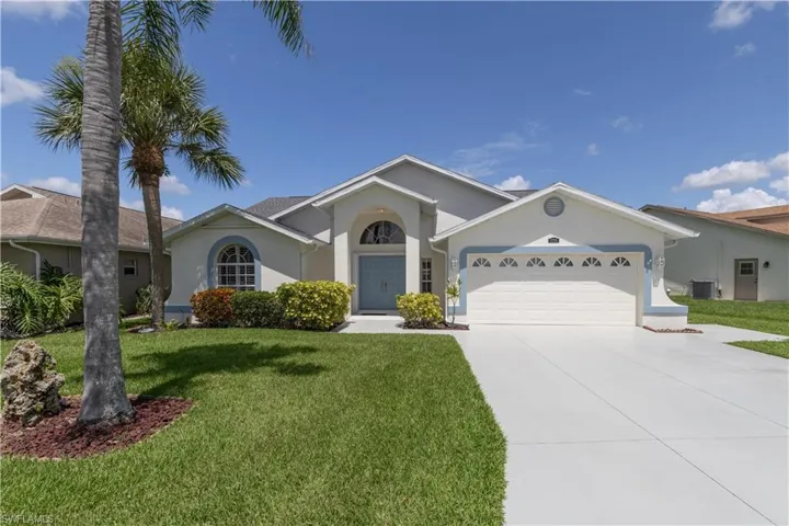 Ranch-style house with a garage, central AC, and a front lawn