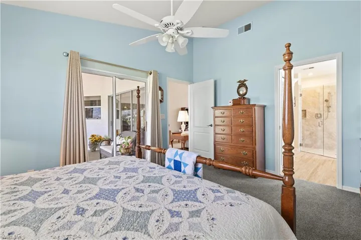 Carpeted bedroom featuring ceiling fan