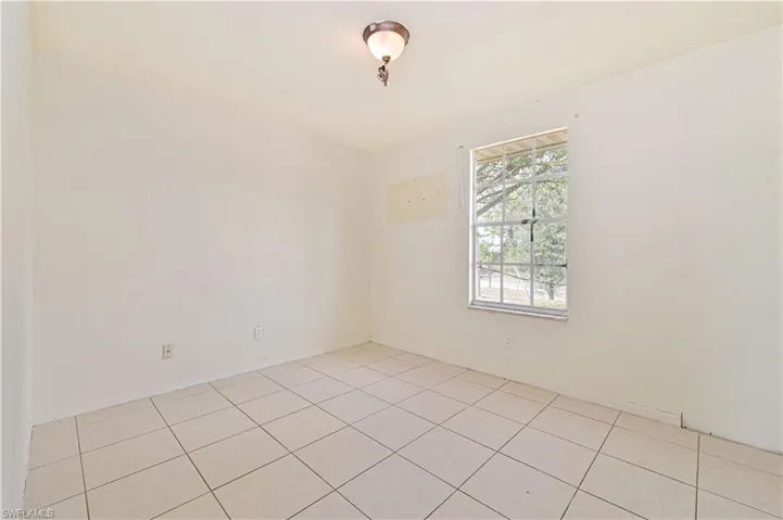 Spare room with light tile patterned flooring