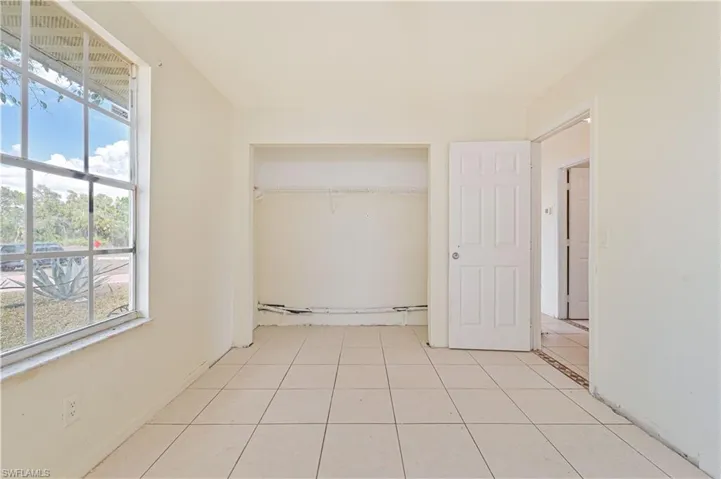 Unfurnished bedroom with light tile patterned floors and a closet