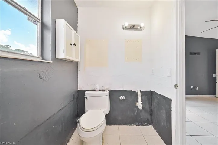 Bathroom featuring toilet and light tile patterned floors