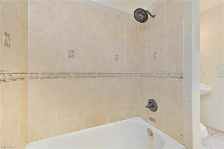Full bathroom featuring toilet and  shower combination