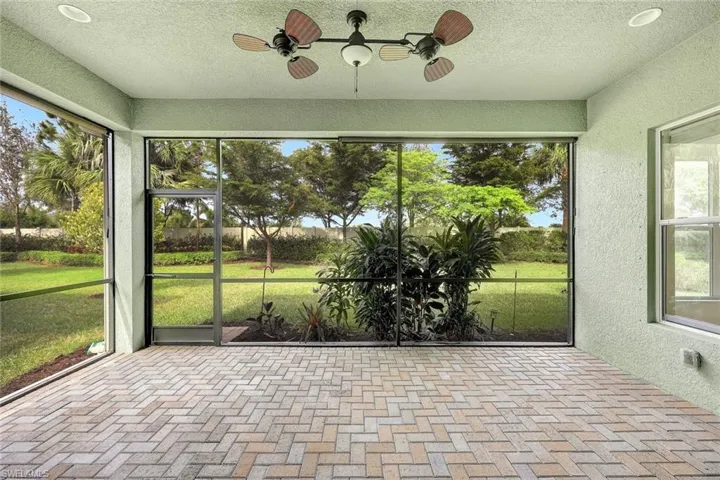 Unfurnished sunroom with ceiling fan