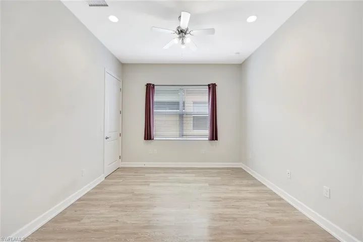Empty room featuring ceiling fan and light wood-type flooring