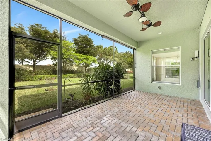 Unfurnished sunroom with ceiling fan
