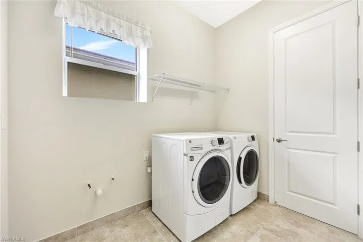Clothes washing area featuring washing machine and dryer