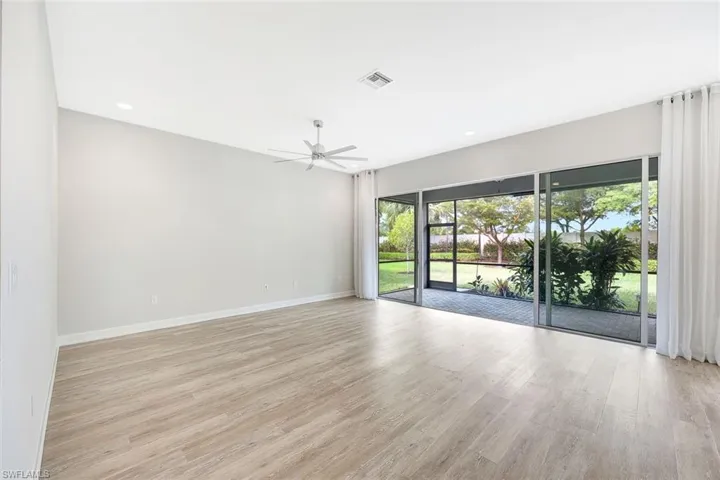 Unfurnished room with ceiling fan and light wood-type flooring