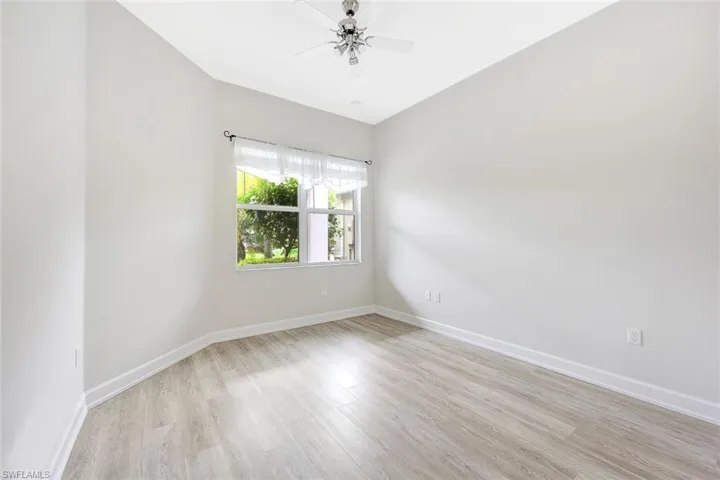 Unfurnished room featuring light hardwood / wood-style flooring and ceiling fan
