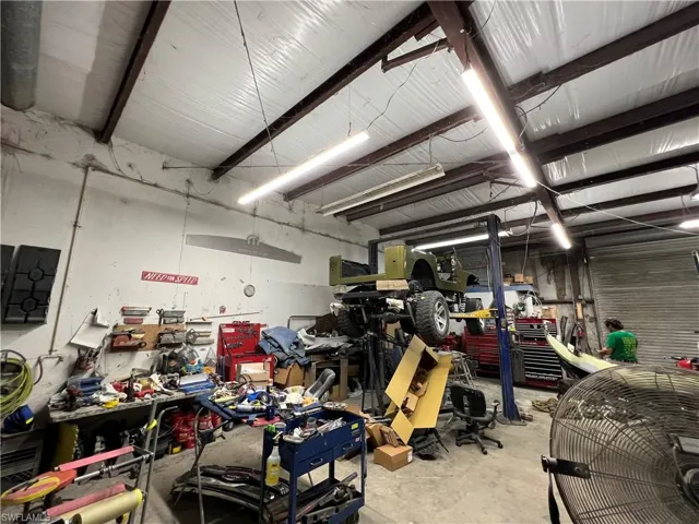 (Bay 2) main auto repair bay with racking and lift